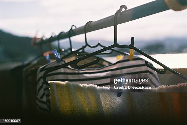 clothes dried in morning light - clothesline ストックフォトと画像