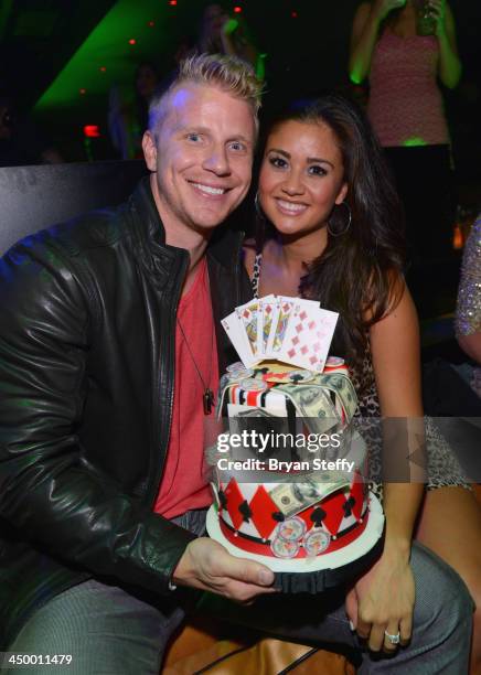 Reality television personalities Sean Lowe and his fiancee Catherine Giudici pose with his birthday cake as they celebrate his birthday at 1 OAK...