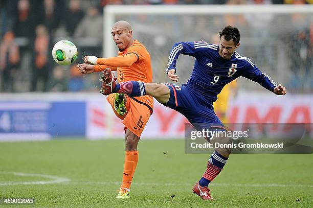 Nigel de Jong of Netherlands is challenged by Shinji Okazaki of Japan during the International Friendly match between the Netherlands and Japan on...