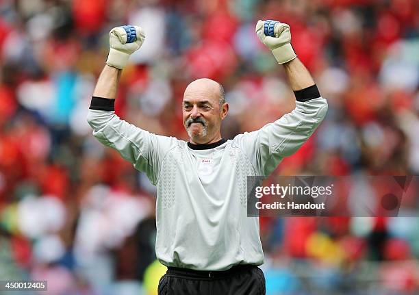 In this handout image provided by the ITM Group, Bruce Grobbelaar celebrates during the Legends match between Liverpool FC Legends and Kaizer Chiefs...