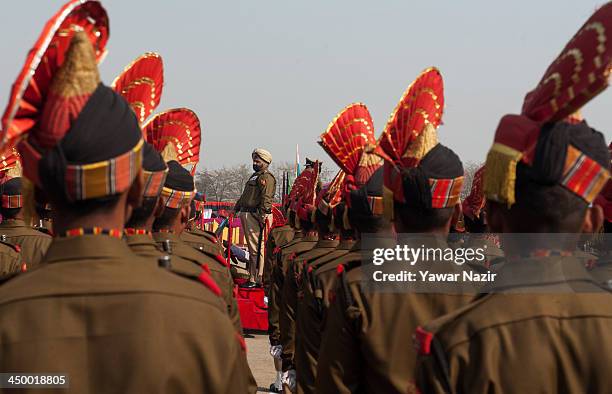 Senior Indian Border Security Force officer takes salute during a passing out parade on November 16, 2013 in Humhama, on the outskirts of Srinagar,...