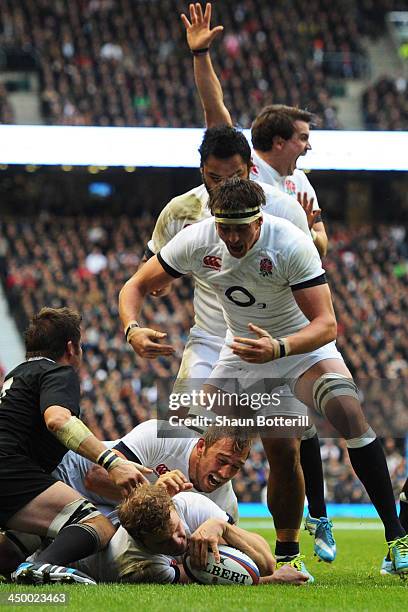 Joe Launchbury of England goes over to score a try underneath Captain Chris Robshaw of England during the QBE International match between England and...