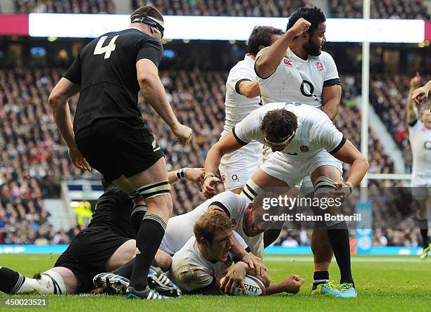 Joe Launchbury of England goes over to score a try underneath Captain Chris Robshaw of England during the QBE International match between England and...