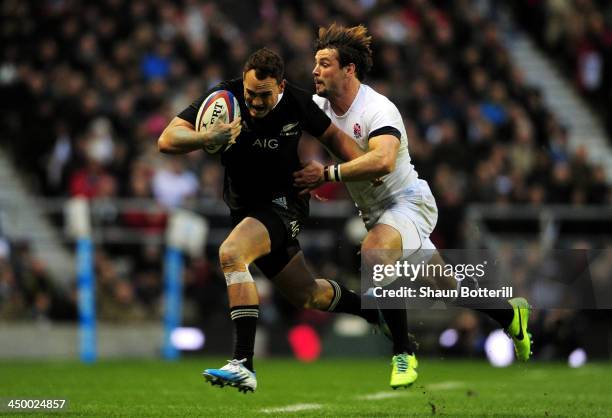 Israel Dagg of New Zealand breaks away from Ben Foden of England during the QBE International match between England and New Zealand at Twickenham...