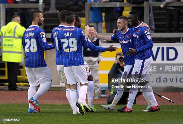 Liam Noble of Carlisle United celebrates with team-mates after he scored the first goal from the penalty spot during the Sky Bet League one match...
