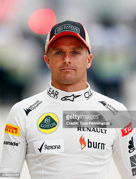 Heikki Kovalainen of Finland and Lotus walks through the pit area during the final practice session prior to qualifying for the United States Formula...