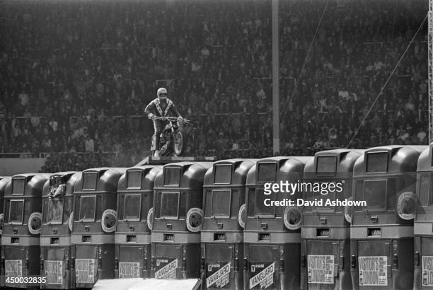 American motorcycle stunt rider Evel Knievel making preliminary checks at the top of the launch ramp before his attempt to jump 13 AEC Merlin buses...