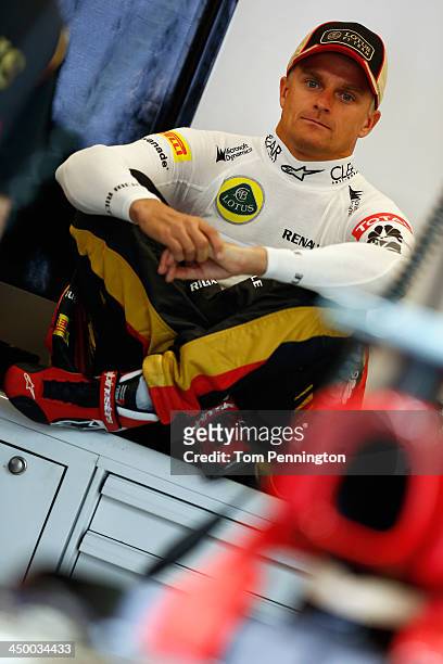 Heikki Kovalainen of Finland and Lotus sits in the garage before the final practice session prior to qualifying for the United States Formula One...