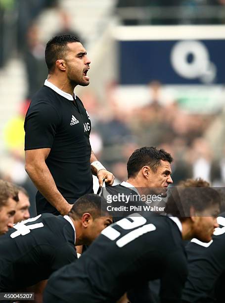 Liam Messam of New Zealand pulls on the shirt of Dan Carter of New Zealand as they perform the Haka during the QBE International match between...