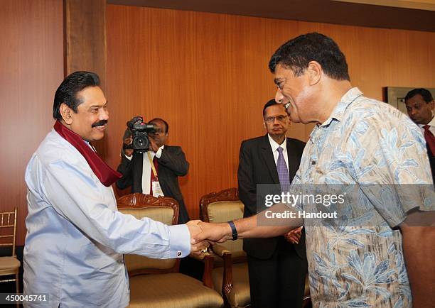 In this handout photo provided by Sri Lankan Government, Sri Lankan Prime Minister Mhainda Rajapaksa shakes hands with Tonga Prime Minister...