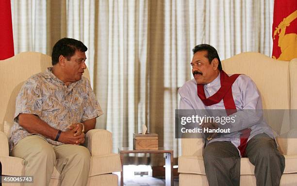 In this handout photo provided by Sri Lankan Government, Sri Lankan Prime Minister Mhainda Rajapaksa talks with Tonga Prime Minister Siale'ataongo...