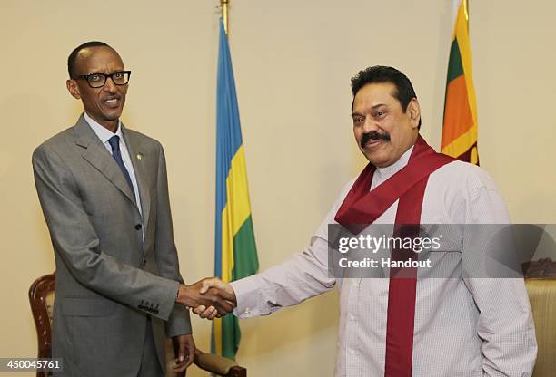 In this handout photo provided by Sri Lankan Government, Sri Lankan Prime Minister Mhainda Rajapaksa shake hands with President of Rwanda Paul Kagame...