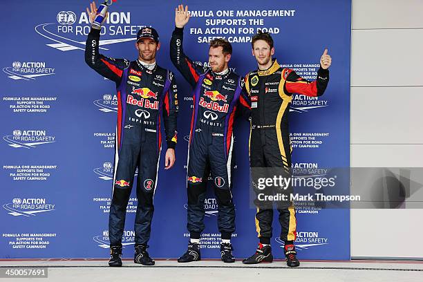 Pole sitter Sebastian Vettel of Germany and Infiniti Red Bull Racing celebrates in parc ferme with second placed Mark Webber of Australia and...