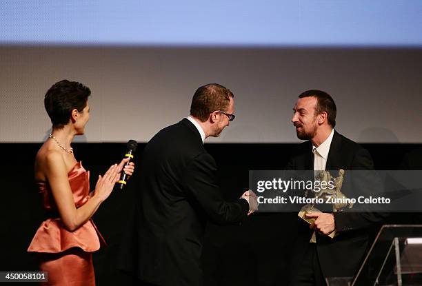 Director Alberto Fasulo shakes the hand of Jury President James Gray after winning the Golden MarcAurelio Award for Best Film for Tir at the...