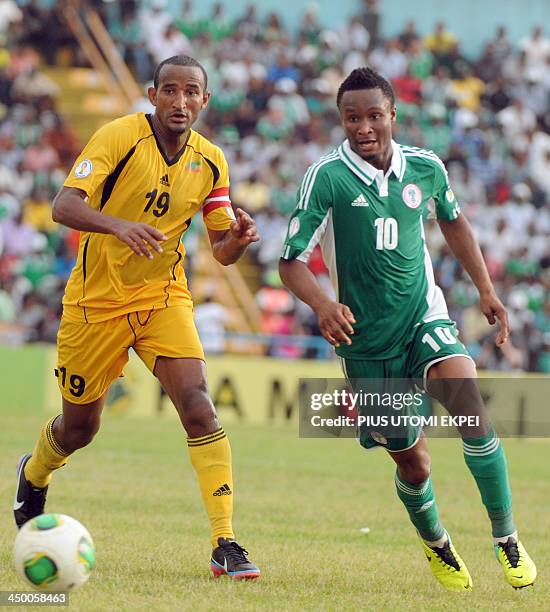 Nigerian midfielder Mikel Obi vies for the ball with Ethiopia's Girma Adane during the FIFA World Cup qualifier in Calabar on November 16, 2013....