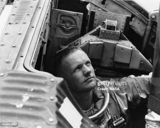American astronaut Neil Armstrong , command pilot for the Gemini 5 backup crew, prepares to close the hatch on the Gemini Static Article 5...