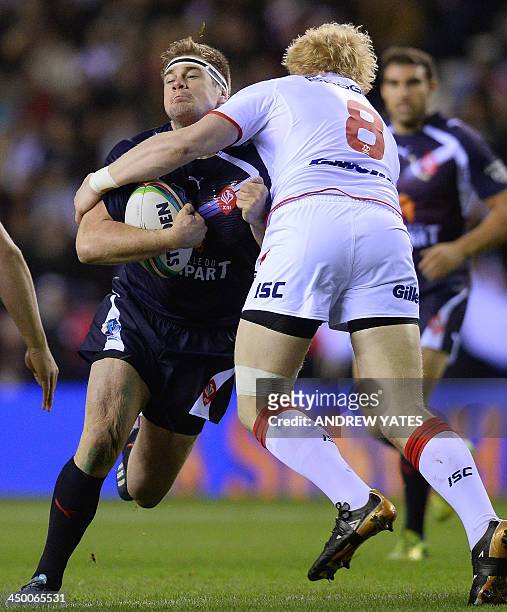 England's James Graham tackles France's Remi Casty during the 2013 Rugby League World Cup quarter-final match between England and France at the DW...