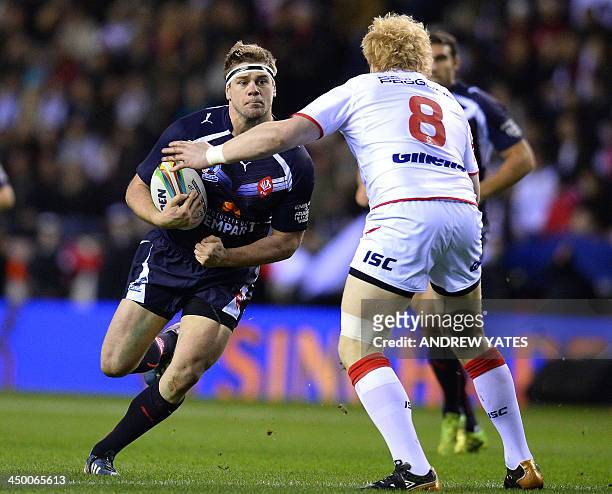 France's Remi Casty runs at England's James Graham during the 2013 Rugby League World Cup quarter-final match between England and France at the DW...