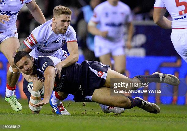 England's Sam Tomkins tackles France's Sebastian Raguin during the 2013 Rugby League World Cup quarter-final match between England and France at the...