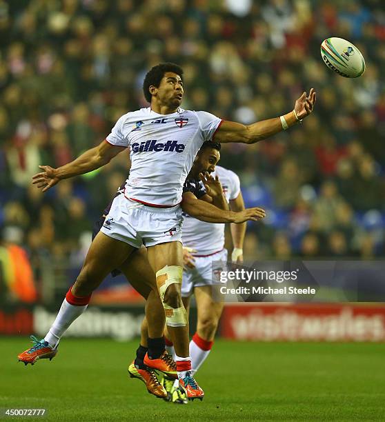 Kallum Watkins of England challenges for the ball alongside Eloi Pelissier of France during the Rugby League World Cup Quarter Final match between...