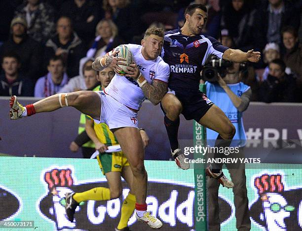 England's Josh Charnley vies with France's Damien Cardace during the 2013 Rugby League World Cup quarter-final match between England and France at...