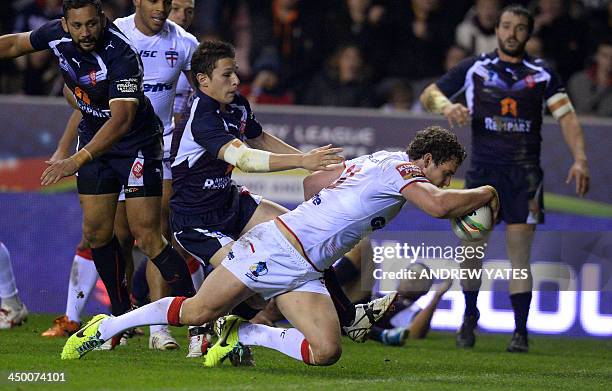 England's Sean O'Loughlin goes in for a try during the 2013 Rugby League World Cup quarter-final match between England and France at the DW Stadium...