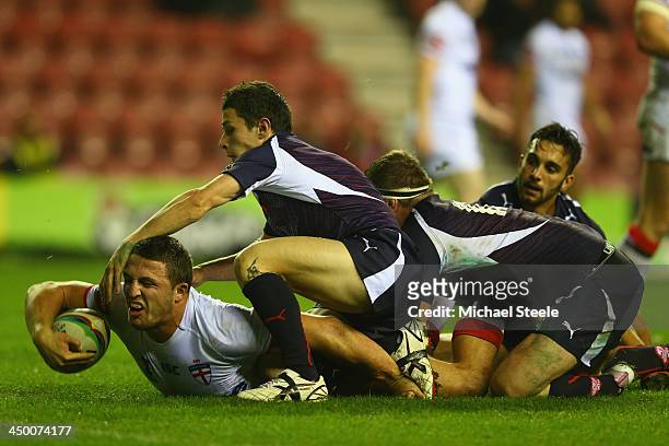 Sam Burgess of England is pulled up just short of the try line by Morgan Escare and Remi Casty of France during the Rugby League World Cup Quarter...
