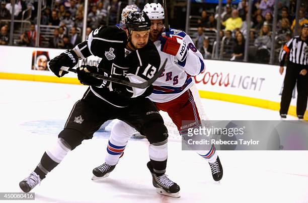 Kevin Klein of the New York Rangers pressures Kyle Clifford of the Los Angeles Kings during the third period of Game One of the 2014 Stanley Cup...