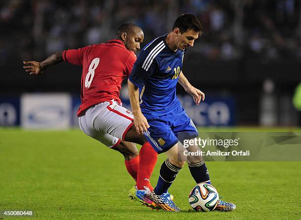 Lionel Messi of Argentina fights for the ball with Khaleem Hyland od Trinidad & Tobago during a FIFA friendly match between Argentina and Trinidad &...