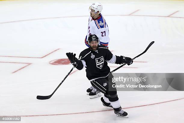 Justin Williams of the Los Angeles Kings celebrates his game-winning goal in overtime in front of Ryan McDonagh of the New York Rangers during Game...