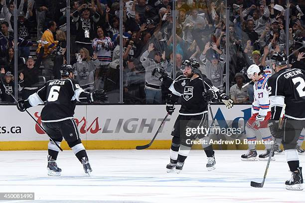 Justin Williams and Jake Muzzin of the Los Angeles Kings celebrate after defeating the New York Rangers in overtime of Game One of the Stanley Cup...