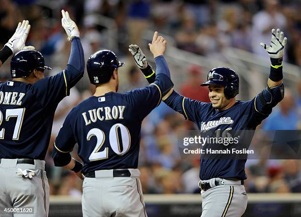 Carlos Gomez and Jonathan Lucroy of the Milwaukee Brewers congratulate teammate Aramis Ramirez on a three-run home run against the Minnesota Twins...