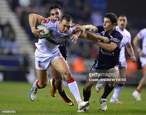 England's Kevin Sinfield holds off France's Morgan Escare and France's Eloi Pelissier during the 2013 Rugby League World Cup quarter-final match...