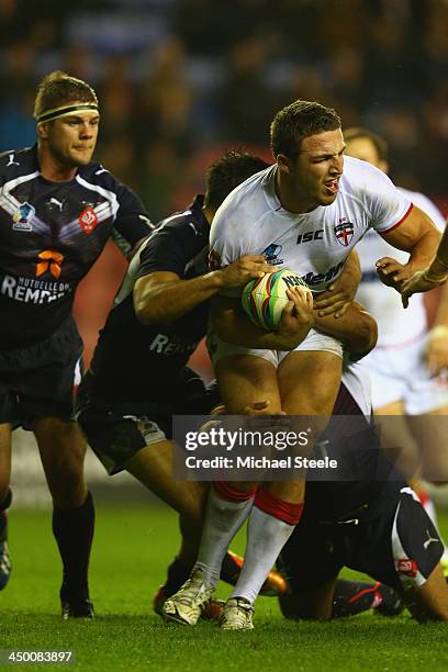 Sam Burgess of England looks to offload during the Rugby League World Cup Quarter Final match between England and France at the DW Stadium on...