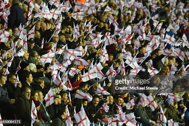 Supporters of England wave flags during the Rugby League World Cup Quarter Final match between England and France at the DW Stadium on November 16,...