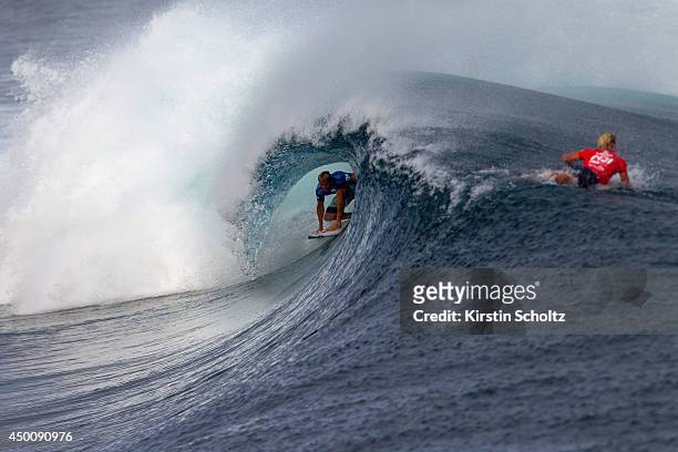Sebastian Zietz of Hawaii surfs while John John Florence of Hawaii paddles over the wave during Round 3 at the Fiji Pro on June 5, 2014 in Tavarua,...