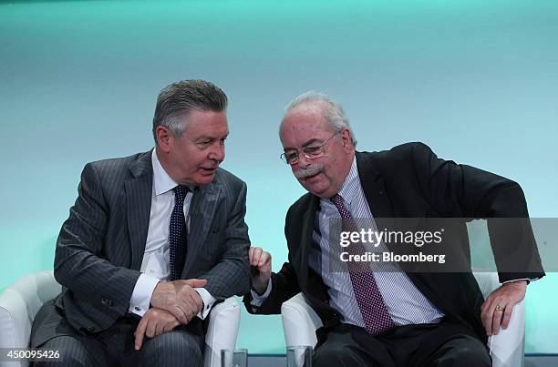 Karel de Gucht, trade commissioner of the European Union , left, speaks with Christophe de Margerie, chief executive officer of Total SA, during the...