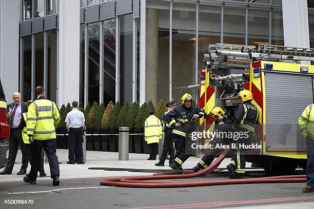 Firemen work in the area as people evacuate The Shard on June 5, 2014 in London, England. The Shard, London's tallest building standing at 310 meters...