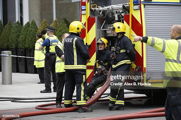 Firemen work in the area as people evacuate The Shard on June 5, 2014 in London, England. The Shard, London's tallest building standing at 310 meters...