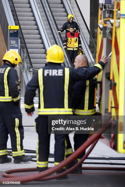 Firemen work in the area as people evacuate The Shard on June 5, 2014 in London, England. The Shard, London's tallest building standing at 310 meters...