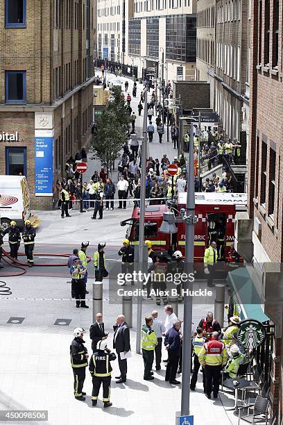 Firemen work in the area as people evacuate The Shard on June 5, 2014 in London, England. The Shard, London's tallest building standing at 310 meters...