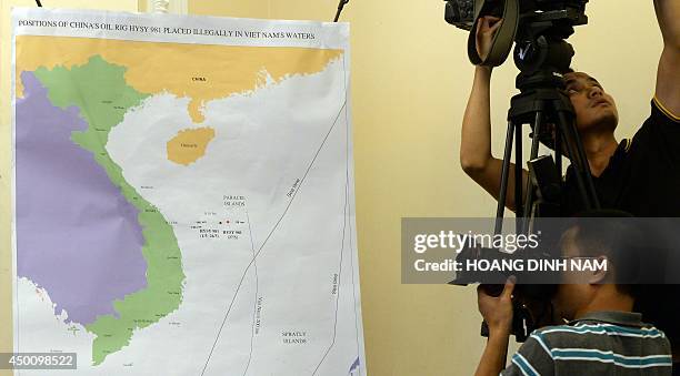 Photographer takes picture of a map showing the position of the Chinese oil rig in the disputed waters at the South China Sea during a press...