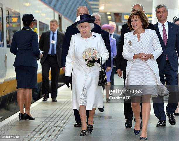 Britain's Queen Elizabeth II walks with Clare Hollingworth, Chairwoman of Eurostar, during a ceremony marking the 20th anniversary of the opening of...