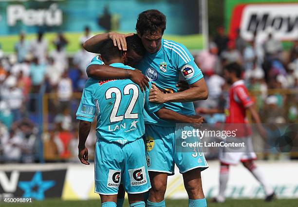 Jose Carlos Fernandez of Sporting Cristal celebrates with William Chiroque and Marcos Ortiz a scored goal against Union Comercio during a match...