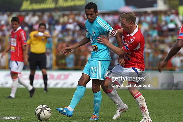 Carlos Lobaton of Sporting Cristal fights for the ball with Joaquin Lencinas of Union Comercio during a match between Union Comercio and Sporting...