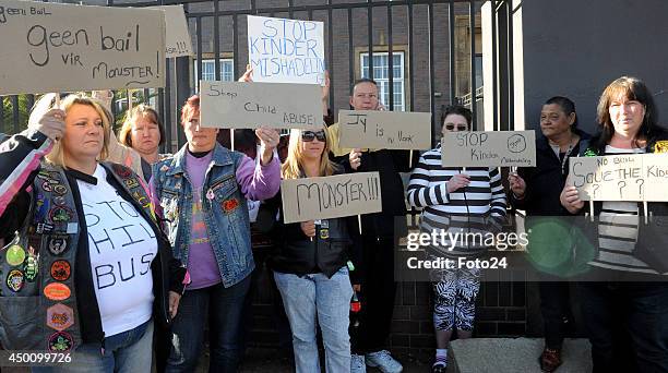 Protesters outside court as the father accused of holding his wife and children captive appears for his bail hearing at the Springs Magistrate's...