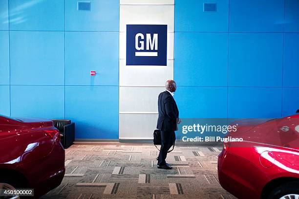 Person walks past the GM logo at the General Motors Technical Center as General Motors Chief Executive Officer Mary Barra holds a press conference on...