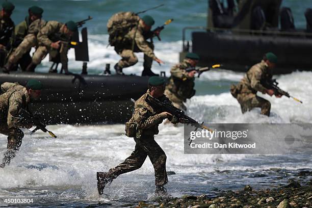 Members of the Royal Marines take part in an amphibious display on Southsea Beach as part of the commemoration of the D-day landings on June 5, 2014...