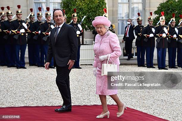 Queen Elizabeth II is welcomed by French President Francois Hollande at the Elysee Presidential Palace as part of a bilateral meeting during an...