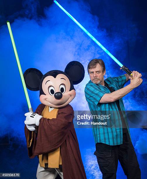 In this handout photo provided by Disney Parks, actor Mark Hamill, who portrayed Luke Skywalker in the 'Star Wars' film saga, poses with Jedi Mickey...